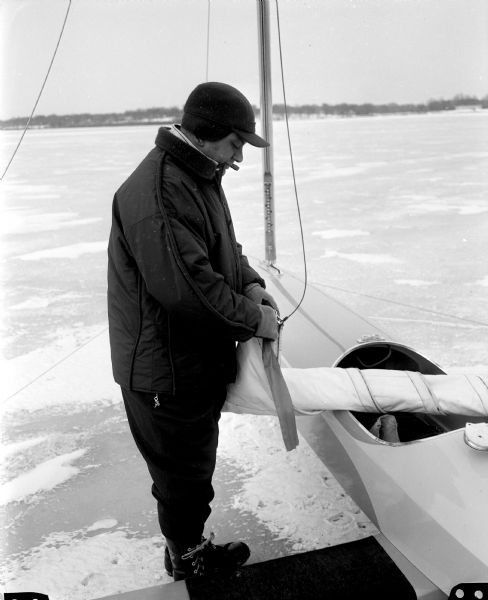 Tom Krehl checks the clamps on an iceboat before going out for a ride.