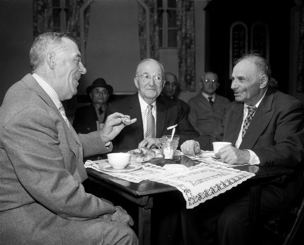 Jacob Isaacs, Albert Dizon, and Jacob Miller (left to right) enjoy dessert at the monthly afternoon party put on by the Council of Jewish Women at the Congregation Adas Jeshurun.