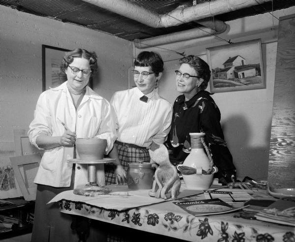 Eloise Haas (left), Helen Burkhardt, Harriet Denniston make pottery during the Madison Art Guild workshop held at the Brobst home recreation room at 211 Lathrop Street.