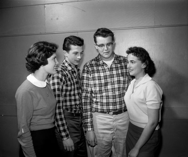 Group portrait of four members of a planning committee for the Teens Against Polio dance. Left to right: Susie Apple, West high School; Bill Glocker, Edgewood High School; Jack Pfister, Central High School, and Mary Beckwith, West High School. Jack Pfister is Madison chairman of Teens Against Polio.