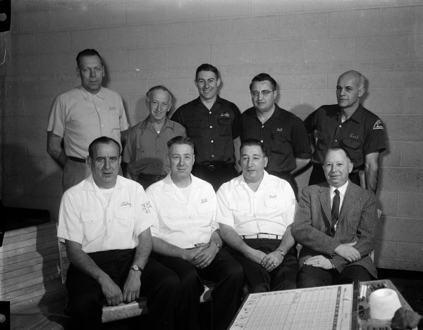 Group portrait of officials for the annual Eagles state bowling tournament to be held at the Madison Eagles Club. Front row, left to right, are: Frank Gottsacker, Bill Stamm, Harold Pinger, and Hardy Endres. Back row, left to right, are: Bill Kuehn, John Bossart, Wendell Smith, Art Boyce, and Earl Webber.