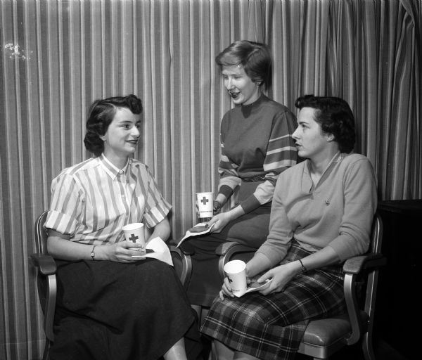 Three Med-Wives Mrs. Gerald (Jane) Stelter,2012 University Avenue; Mrs. Donald (Carolyn H.) Pritzl, 509 State Street; and Mrs. John (Dorothy) Riesch 318 Pawling Street, bridge chairman drink coffee after volunteering at the Dane County Red Cross Building. The Med-Wives is an organization of wives of University of Wisconsin medical students.