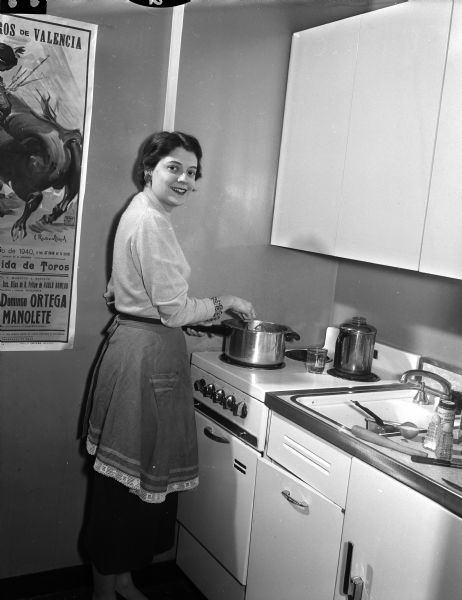 Jean Ziegler cooking spaghetti for a dinner party at her apartment at 122 East Gilman Street, Apt. 205.
