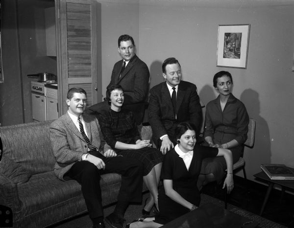Guests and hostesses gather before serving dinner at an apartment party. Left to right: Pat Pidcoe, Bill Meuer, Bill Chatterton, Anne Pidcoe, Harry Kessenich, Jr., and Jean Ziegler.