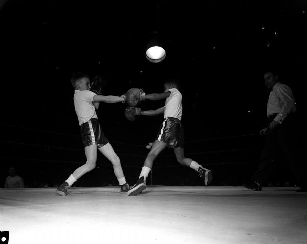 Nine-year-old Jim Grann (left) and Bill Withers box during the "Little Badgers" exhibition contests prior to the Wisconsin-San Jose State boxing match at the University of Wisconsin Field House.