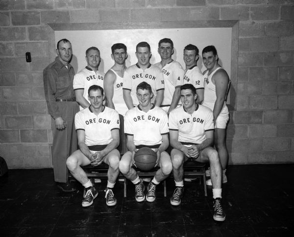 Group portrait of ten uniformed men who are the Oregon Business Men's basketball team and the champions in the Suburban Home Talent League. Front row, eft to right are: Jack Shell, Dick Shell, and Paul Smith. Back row are: Bob Gefke, Paul Nelson, Werner Eugster, Dick Pernot, Les Dalsoren, John Eugster, and Jim Flint.