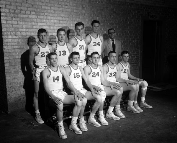 Team group portrait of Superior Central High School basketball team. The team is participating in the state high school basketball tournament in the U.W. field house in Madison.