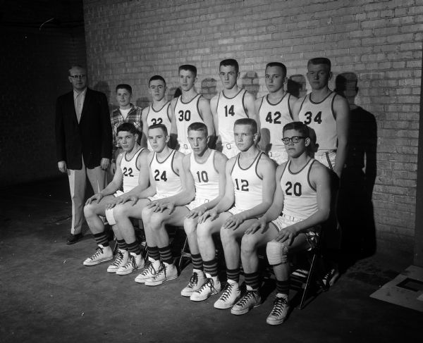 Group portrait of the Osseo High School Basketball Team. The team is participating in the State High School Basketball Tournament.