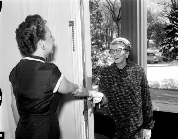 Mrs. Vernon W. (Helen) Thomson, Wisconsin's new first lady, greets Mrs. Julian (Cath) Swan of 3918 Yuma Drive at the executive residence, 101 Cambridge Road in Maple Bluff.