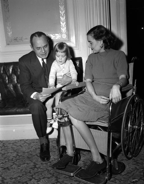 Governor Walter Kohler sits with 2 1/2 year old Deborah Foster and her mother Ruth Foster, both polio victims. Governor Kohler is proclaiming January as "March of Dimes" month.