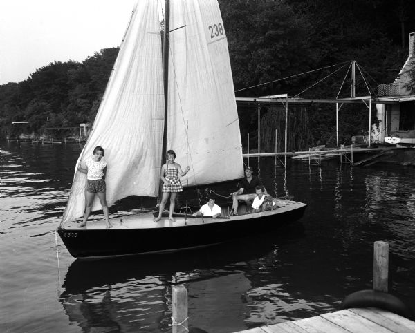 Jane and Kenneth White and their daughters, Sue (left), Kay, and Barbara, and the family dog, Perky, sailing in their lightning class sailboat on Lake Mendota.