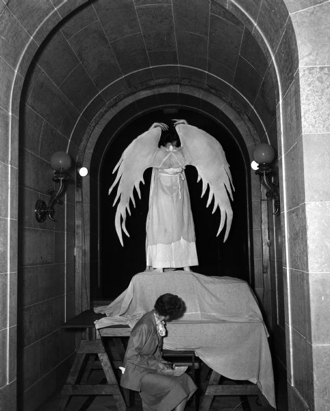 An angel perches in an archway of the Wisconsin State Capitol, being watched by an assistant during the annual Christmas Pageant.