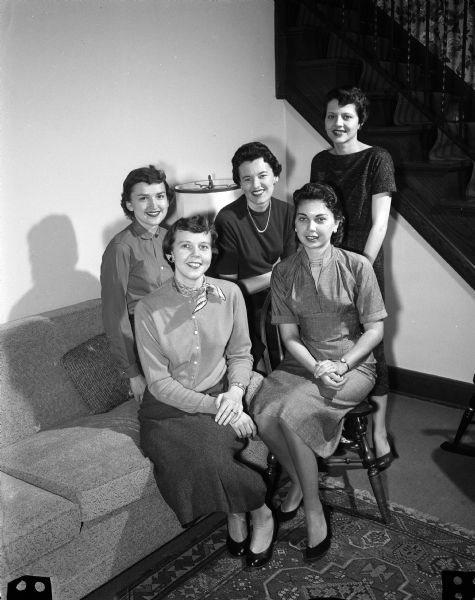 Group portrait of members of a Junior Chamber of Commerce Auxiliary planning committee. Front row, left to right: Mrs. Gerald Padgham and Nancy Piper. Back row: Delores Meagher, Barbara Theg, and Margaret Larson. The committee is planning a puppet show to benefit its work for cerebral palsy victims.