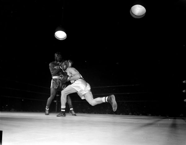 Wisconsin's Ron Marshall (right) lands a right to the mid-section of Huel Washington in their 156-pound bout during the boxing match between the University of Wisconsin and Michigan State at the University of Wisconsin field house.