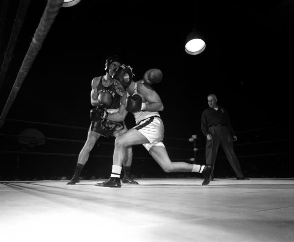 Wisconsin's Ron Freeman (right) and Michigan State's John Gehan trade jabs in their bout during the boxing match at the UW field house.
