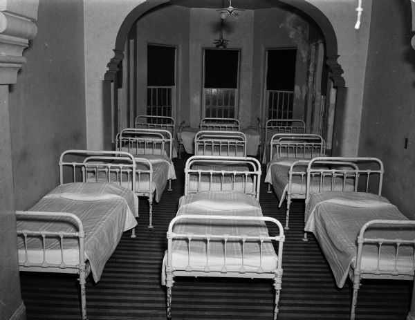 View of nine empty beds in a Mendota State Hospital ward (Mendota Mental Health Institute) at 301 Troy Drive.