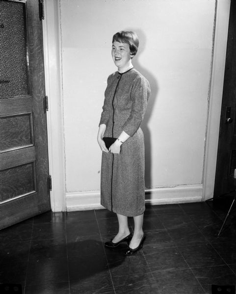 Karen Olson, a senior at Wisconsin High School, models appropriate clothing for a job interview. She is wearing a tailored dress, hose ("a must for career women of any age"), and low-heeled black pumps.