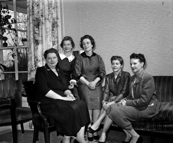 Group portrait of the committee chairmen for the annual spring banquet of the Catholic Woman's Club. Members include, left to right: Elizabeth Teslaw, evening division; Janet Fleury, music; Margaret Schmitz, publicity; Gertrude Spevacek, tickets; Margaret Stephan, co-chairman of decorations.