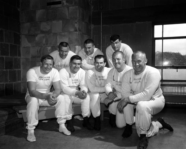 University of Wisconsin alumni football players pictured are linemen Ken Huxhold, Dave Suminski, George O'Brien, Jerry Smith, Bill Albright, Jim Temp, Norm Amundsen, and Norbert Esser.
