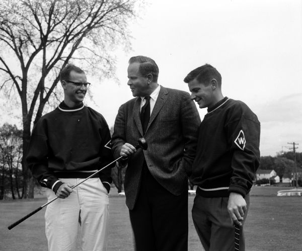 University of Wisconsin golf coach and players John Jamieson, Roger Rubendall, and Dave Forbes, are shown at the Maple Bluff Country Club, home course for the Badgers.