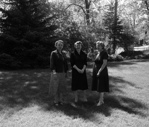 Mildred M. Morganson, Catherine M. Barber, and Sarah S. Longenecker posing outdoors while planning the West Side Garden Club's annual spring party and silver tea.