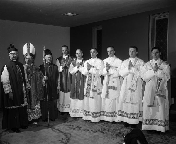 Six new Catholic priests follow ordination services at St. Raphael's Cathedral. Shown with the priests are, left to right: Msgr. Edward Kinney, Bishop William O'Connor and Msgsr. Jerome Hastrich. The new priests, all assigned to the Madison Diocese, are (left to right): the Rev. John Walsh, Chicago; the Rev. Francis Steffen, Platteville; the Rev. David Runde, Hazel Green; the Rev. Leo Joyce, Briggsville; and the Rev. Bernard Deitelhoof, Madison.