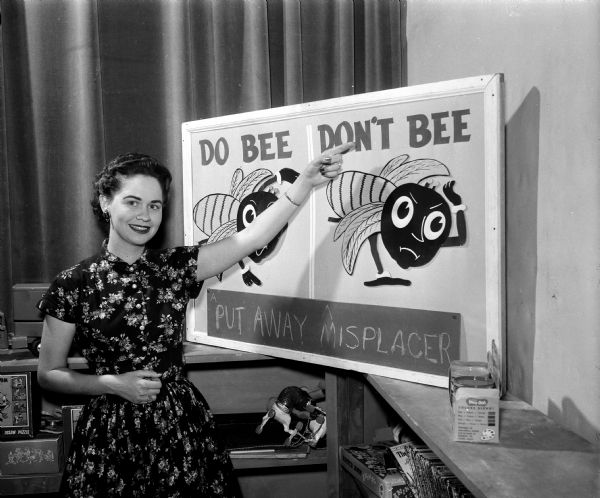 "Miss Nancy" (Eunice Spindler) posing with a Good Behavior Poster on the set of WMTV's Romper Room program.