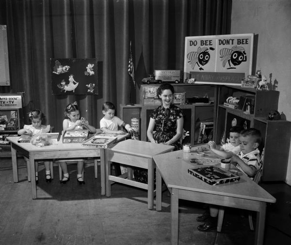"Miss Nancy" (Eunice Spindler) and five "pupils" sit at tables on the set of WMTV's Romper Room.