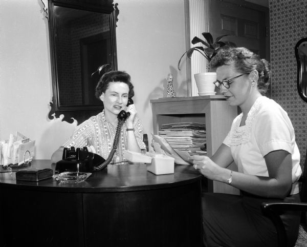 Portrait of Martha Stolz and Gladys Murphy, two volunteer members of the Red Cross blood donor committee, who make calls to request blood donations.