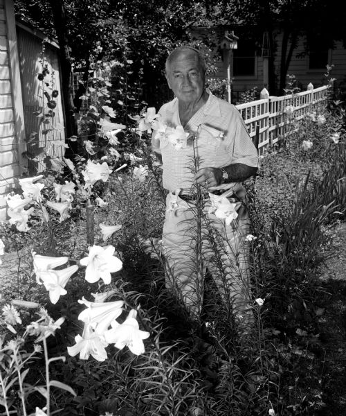 Outdoor portrait of T.B. Luhman in his garden of lilies.