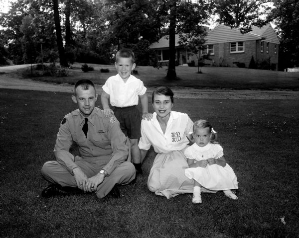Outdoor group portrait of Captain and Mrs. (Mary Day Robinson) John O. Batiste with their children, John (5), and Elizabeth (3). The family is in Madison visiting John's parents, Mr. and Mrs. W.N. Batiste, and to visit Mary's parents in Jefferson, Dr. and Mrs. A.H. Robinson.