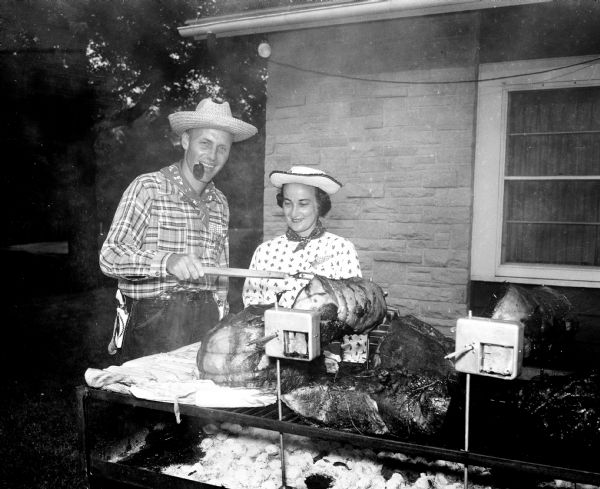 Douglas and Betty Oldenburg testing the barbecued meat at Blackhawk Country Club's Western Party.