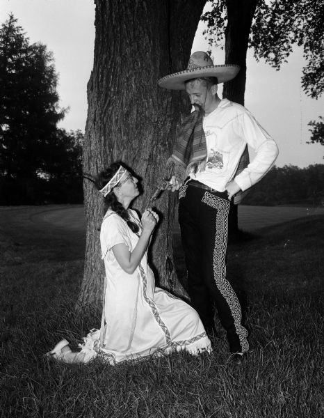 Arliss Nelson dresses as a Native American maiden, and John B. Nelson dresses as Pancho Villa while attending Blackhawk Country Club's Western Party.