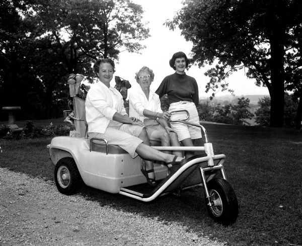 Three women wait to tee off during the second round of the monthly inter-club play at the Blackhawk Country Club. From left are: Katherine Mauer of Maple Bluff, Dorothy Steiro of Blackhawk, and Janet Roth of Maple Bluff.