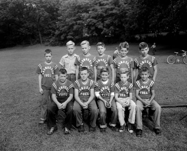 Group portrait of the Rasmussen Fuel boys baseball team in the Midget League.