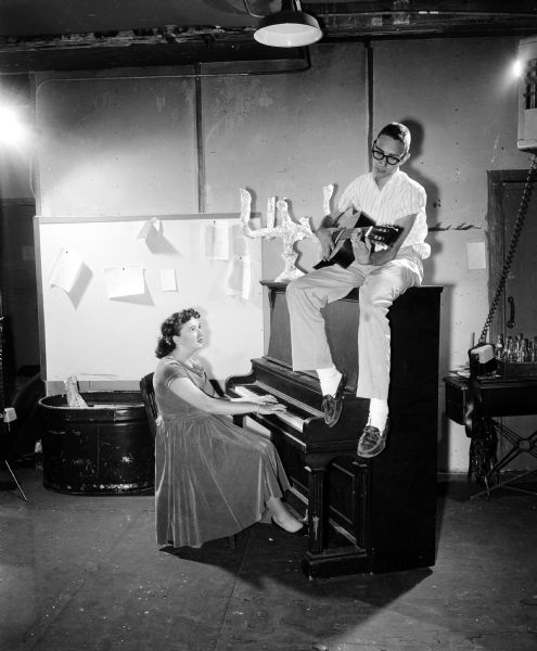 Kathy McCloskey, at the piano, and Andy Rothblatt, with a guitar, rehearse a Civil War ballad for the tenth anniversary celebration of the Madison Youth Summer Theater.
