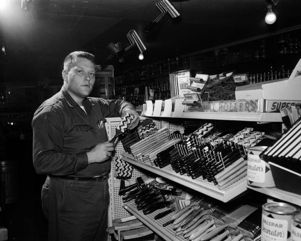 Harold Van Gordon, manager of the paint department, poses by the paint brush display in the paint department at C & P Shopping Center at 3830 Atwood Avenue.