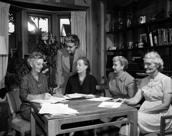 Group portrait of the members of the Madison Civics Club public affairs committee seated around a table. Left to right are: Mrs. Margaret Russell, Mrs. Glenn Wise, Mrs. Rachel Ewbank, Mrs. Gladys Dean, and Mrs. Isabelle Elder.