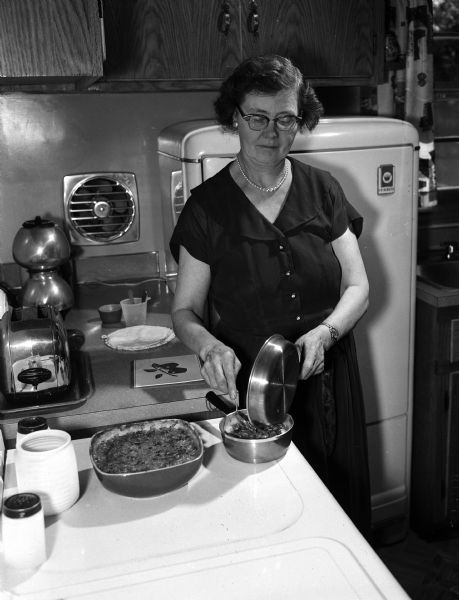 Mrs. Harry Flemming preparing a seafood and wild rice luncheon. She is the grand prize winner of the casserole category in the Wisconsin State Journal's second annual recipe contest.