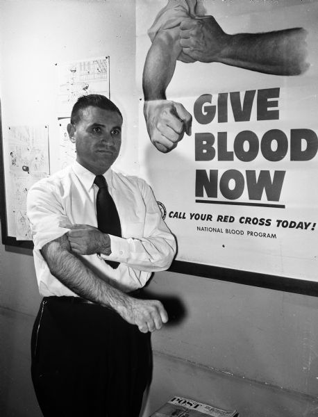 Edward R. Brann prepares to give his third gallon of blood during a Red Cross blood drive.