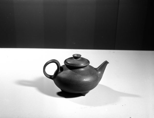 The history of tea service was shown by a display of tea pots in the Wisconsin Historical Society Women's Auxiliary exhibit, "Tides of Taste." The image shows a stoneware tea pot of Scandinavian design.