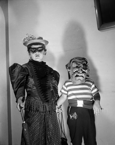 Susie Addington (left), age 5, and her sister, Carol, age 2, pose while dressed in Halloween costumes.