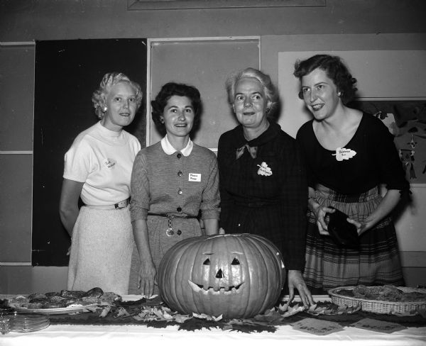 Mrs. Marie Pease, the wife of the Truax Field base commander, greets three of the wives of newly-arrived officers at a party given by the Officers Wives' Club. From left are: Mrs. W.K. Winbigler, Mrs. Pease, Mrs. Donald Montgomery, and Mrs. John P. Fox.