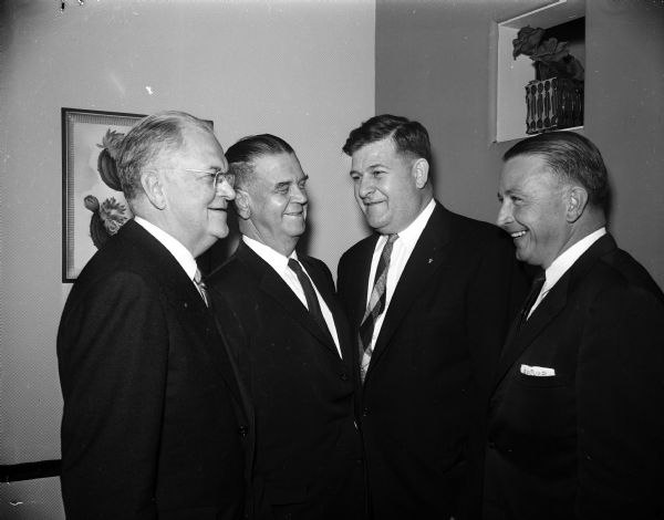 Group portrait of Four Elks Club officials. From left are: Floyd Thompson of Chicago, past grand exalted ruler and former justice of the Illinois Supreme Court; H.L. Blackledge of Kearney, Nebraska, grand exalted ruler; Richard F. Williams, exalted ruler of Madison Lodge 410; and Kenneth E. Sullivan, past exalted ruler of the Madison lodge.