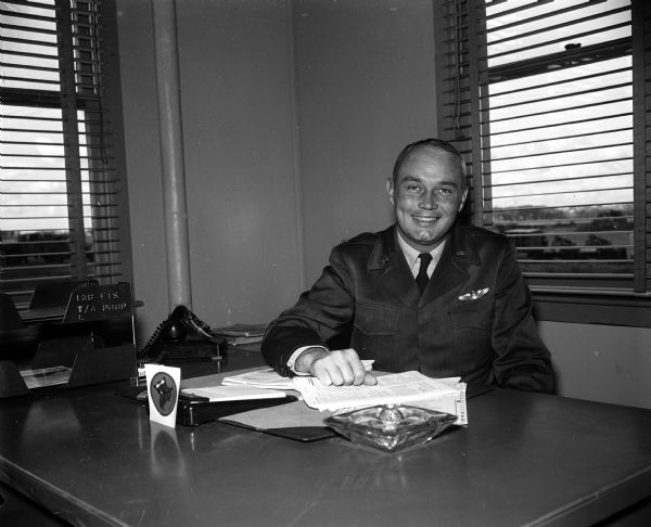 Lt. Col. Lassiter Thompson sits behind his desk at Truax Field. He is the newly appointed commander of the 61st Fighter Interceptor Squadron.