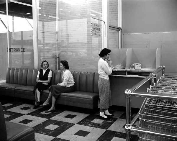 Two women relax in the lounge of Kroger's Midvale Plaza, 525 South Midvale Boulevard, while shopping at the supermarket. The lounge is a special feature of this new store.