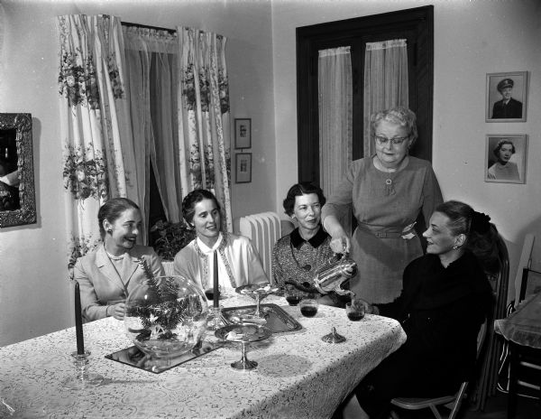 A group gathers for the Madison Art Guild's annual Christmas party at the home of Doris Brobst. Shown: Jean Watson, Mrs. James M. Wilkie (Cross Plains), Mrs. W.V. Geunther, Doris Brobst, and Fern Thompson.