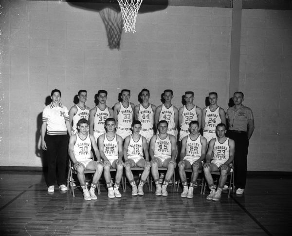 Group portrait of 13 basketball players, a team manager, and the coach, Frank Hlavac.