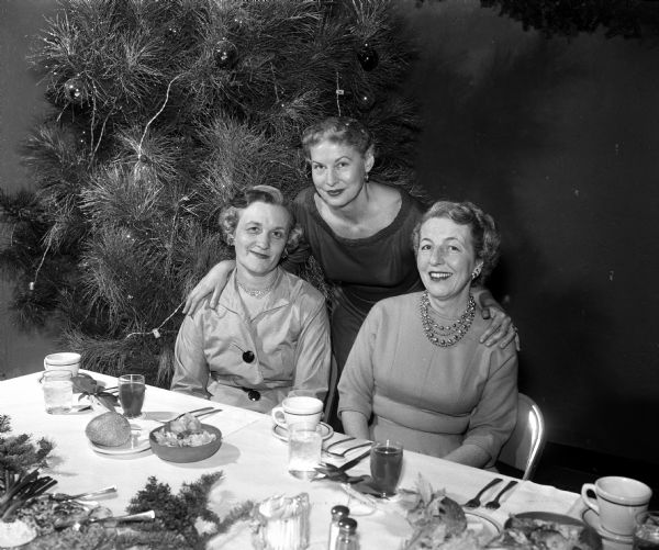 Group portrait of three past presidents of the Four Lakes Secretary's Association at a holiday dinner party. They include Paige Hampton, Marion Dengel, and Louise Doyle.