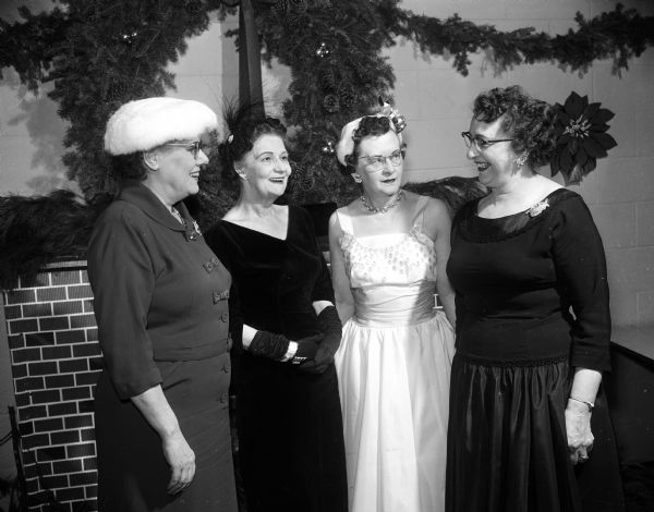 Group portrait of four Lakes Secretary's Association committee members who arranged a holiday social event. They include Hazel Lerwick, Elsie Horstmeyer, Mabel Gunderson, Charlotte Haugen